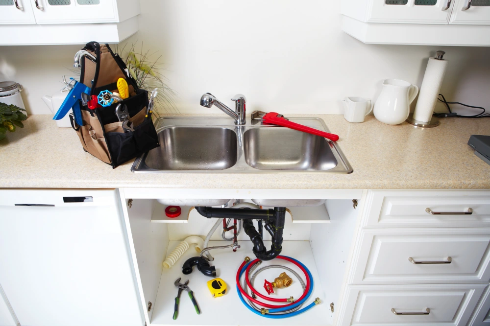 Plumbing tools on the kitchen. Renovation background.